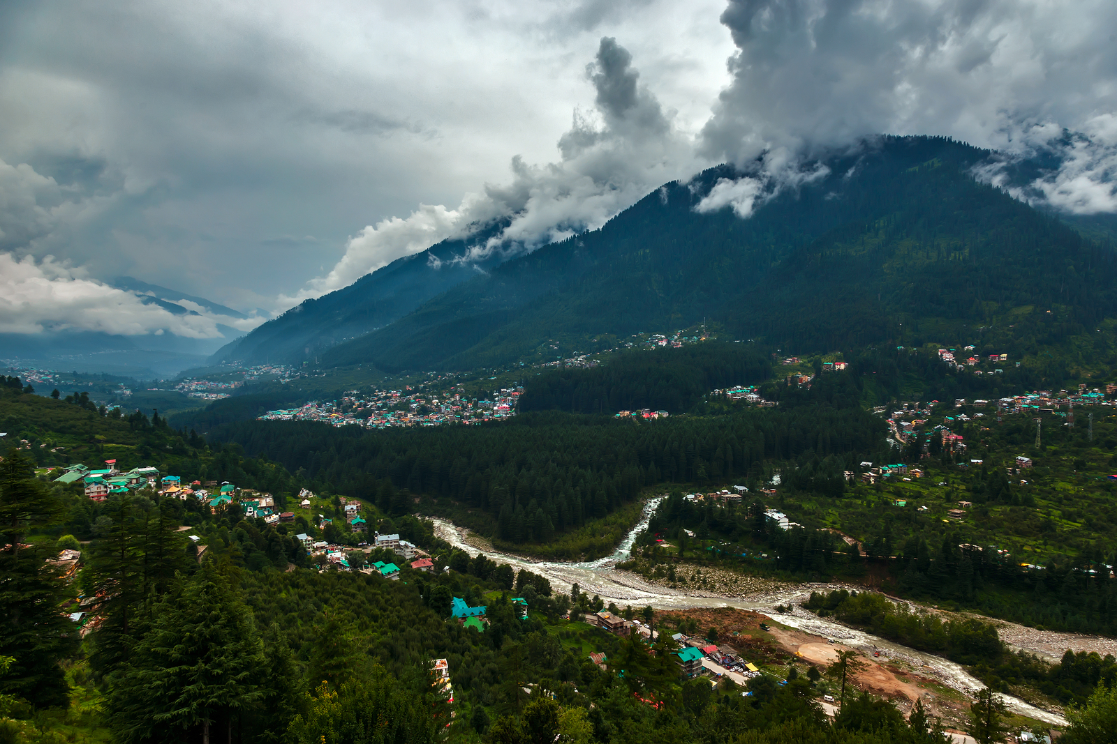 Himalayan city Manali with green forest and clouds